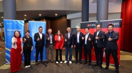 DBS Group CEO Tan Su Shan (centre in red) and Forest Lin (fifth from right), Corporate Vice President of Tencent and Head of Tencent Financial Technology, signed an MOU to enhance mutual cross-border payment connectivity at the Singapore FinTech Festival 2025.